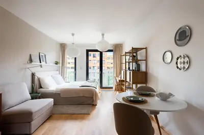 a living room with a bed and a table at Stylish and Comfortable Studio in Prague