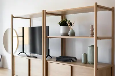 a tv on a wooden shelf in a living room at Stylish and Comfortable Studio in Prague