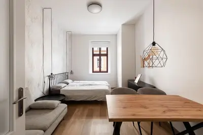 a living room with a bed and a table at Good Mood in the Zizkov Hood Prague in Prague