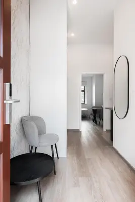 a living room with a chair and a mirror at Good Mood in the Zizkov Hood Prague in Prague