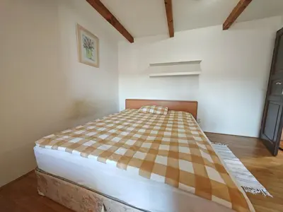a bedroom with a checkered bed in a room at Elegant and Spacious 4BR Loft in Charming Vinohrady in Prague