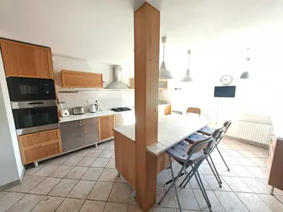 a kitchen with a table and chairs in it at Elegant and Spacious 4BR Loft in Charming Vinohrady in Prague