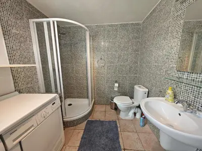 a bathroom with a toilet and a tub and a sink at Elegant and Spacious 4BR Loft in Charming Vinohrady in Prague