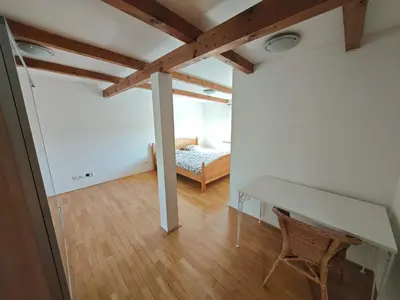 a room with a table and a bed in it at Elegant and Spacious 4BR Loft in Charming Vinohrady in Prague