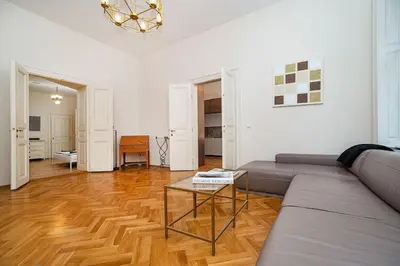 a living room with a couch and a table at Museum Quarter Elegance Suite in Prague