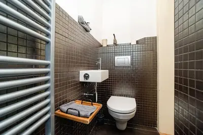 a small bathroom with a toilet and a sink at Museum Quarter Elegance Suite in Prague