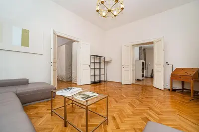 a living room with a couch and a table at Museum Quarter Elegance Suite in Prague
