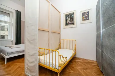 a yellow crib in a room with a bedroom at Museum Quarter Elegance Suite in Prague