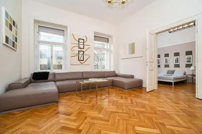 a living room with a couch and a wooden floor at Museum Quarter Elegance Suite in Prague