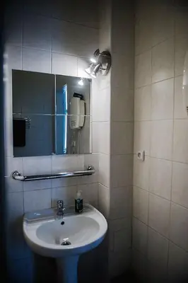 a bathroom with a sink and a mirror at Stylish and unique 2 bedroom flat with balcony in Letna in Prague