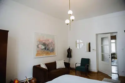 a living room with a couch and a chair at Stylish and unique 2 bedroom flat with balcony in Letna in Prague