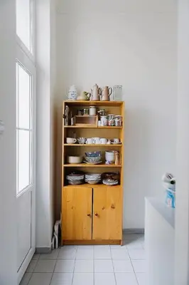 a wooden cabinet with dishes on it in a room at Stylish and unique 2 bedroom flat with balcony in Letna in Prague