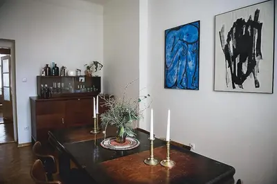 a dining room with a table with two candles on it at Stylish and unique 2 bedroom flat with balcony in Letna in Prague