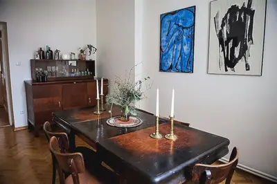 a dining room with a table with candles on it at Stylish and unique 2 bedroom flat with balcony in Letna in Prague