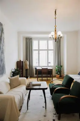 a living room with a couch and a table at Stylish and unique 2 bedroom flat with balcony in Letna in Prague