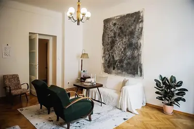 a living room with a couch and a table at Stylish and unique 2 bedroom flat with balcony in Letna in Prague