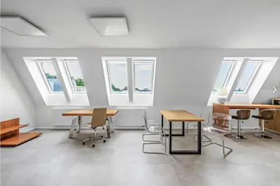 a room with tables and chairs and windows at Stylish 3-Room Flat City Views in Prague
