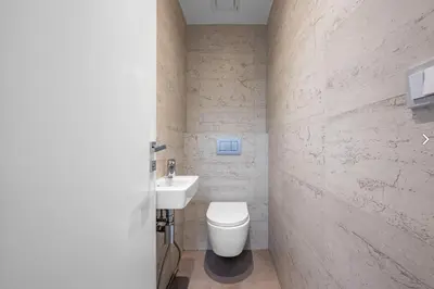 a bathroom with a white toilet and a sink at Stylish 3-Room Flat City Views in Prague