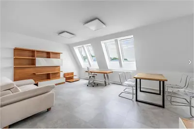 a living room with a couch and a table at Stylish 3-Room Flat City Views in Prague
