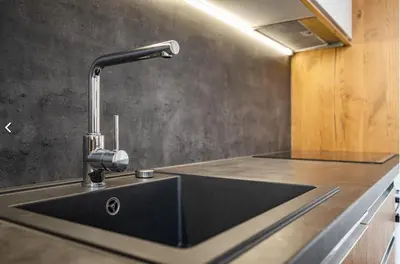 a kitchen with a sink with a faucet at Stylish 3-Room Flat City Views in Prague