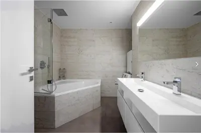 a white bathroom with a tub and a sink at Stylish 3-Room Flat City Views in Prague