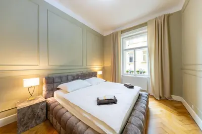 a bedroom with a bed and a window at Apartment Manes in Prague