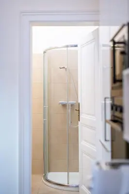 a shower with a glass door in a bathroom at Apartment Manes in Prague