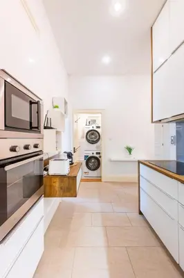 a kitchen with white cabinets and a counter top at Apartment Manes in Prague