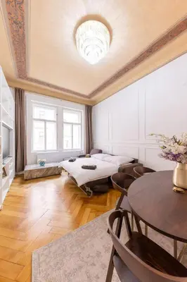 a large room with a bed and a table at Apartment Manes in Prague