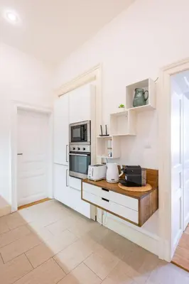 a kitchen with white walls and a counter with appliances at Apartment Manes in Prague
