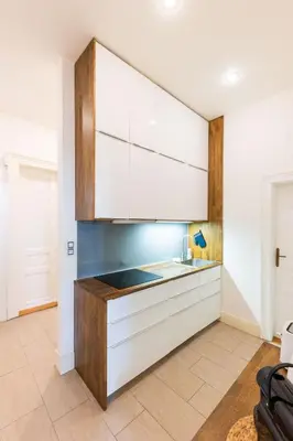 a kitchen with white cabinets and a sink at Apartment Manes in Prague