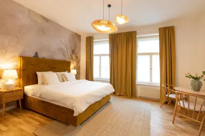 a bedroom with a large bed and a table and chairs at Welcometothejungleapartment in Prague
