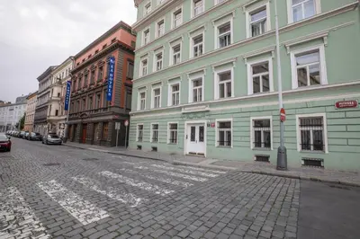 a cobblestone street in a city with buildings at Welcometothejungleapartment in Prague