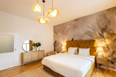 a bedroom with a large bed and a wall mural at Welcometothejungleapartment in Prague