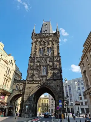 a tall building with an arch in a city at Apartmány Podol in Prague