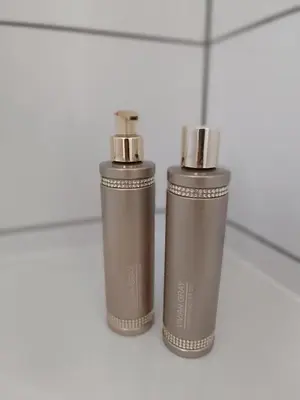 two silver thermos bottles sitting on a tile floor at Apartmány Podol in Prague
