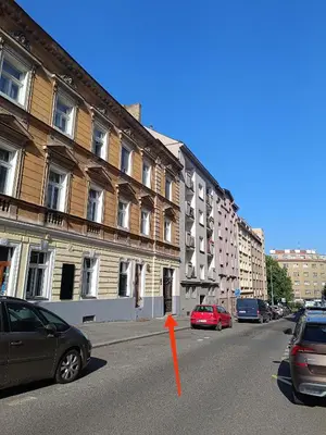 a street with cars parked in front of buildings at Apartmány Podol in Prague
