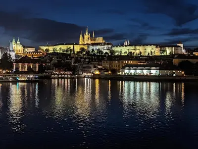 a view of a city from the water at night at Apartmány Podol in Prague