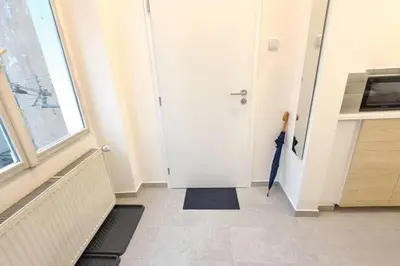 a hallway with a white door and an umbrella at Cozy studio in Prague favorite neighborhood in Prague