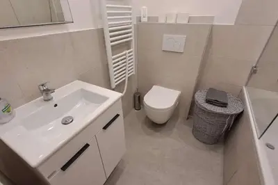 a white bathroom with a sink and a toilet at Cozy studio in Prague favorite neighborhood in Prague