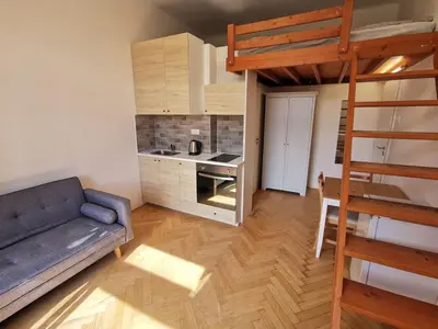 a living room with a couch and a bunk bed at Modern studio with excellent transport links in Prague