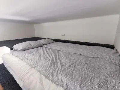a bed with two pillows on it in a bedroom at Modern studio with excellent transport links in Prague
