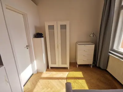 a room with a cabinet and a dresser and a window at New petite studio in bohemian suburb in Prague