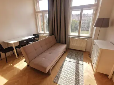 a living room with a couch and a table at Cosy and simple well located studio in Prague