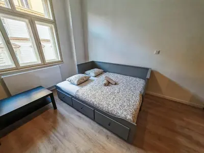 a bedroom with a bed with a teddy bear on it at Quiet Studio in Hip Zizkov in Prague