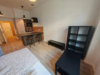 a room with a kitchen and a living room at Quiet Studio in Hip Zizkov in Prague