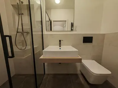 a bathroom with a sink and a shower and a toilet at Quiet Studio in Hip Zizkov in Prague