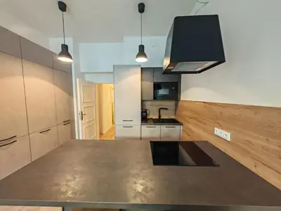 a large kitchen with a large island in the middle at Quiet Studio in Hip Zizkov in Prague