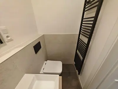a small bathroom with a toilet and a sink at Quiet Studio in Hip Zizkov in Prague