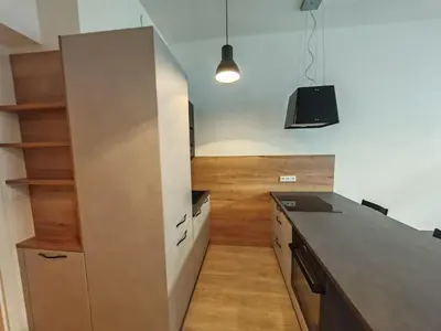 a kitchen with a counter top and wooden floors at Quiet Studio in Hip Zizkov in Prague